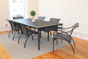 black aluminum dining table with black aluminum dining arm chairs with mesh seat